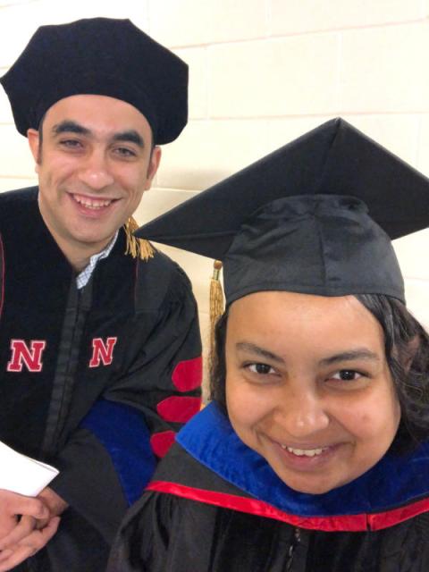 Faculty member and graduate posing for selfie